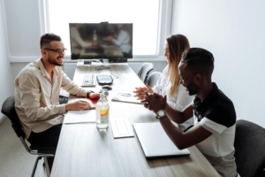 Consultant helping two workers